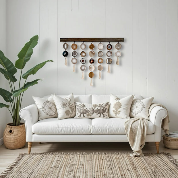 a white couch sitting in a living room next to a potted plant