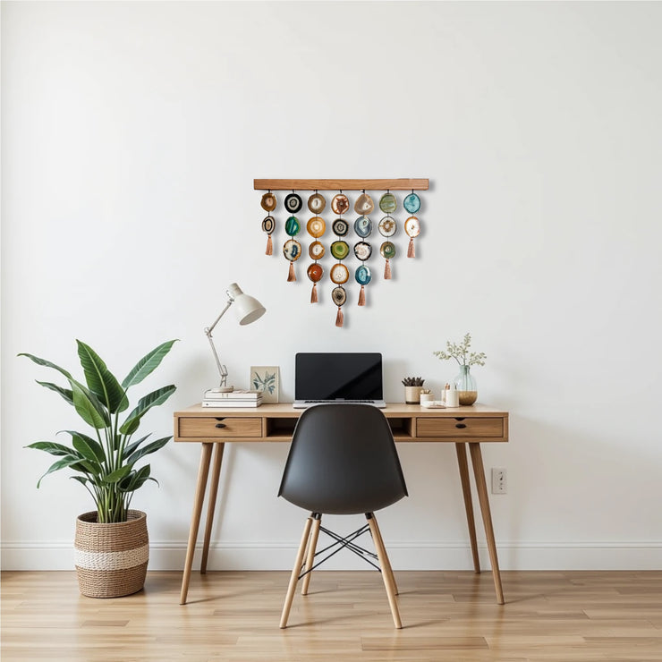 a desk with a laptop and a potted plant