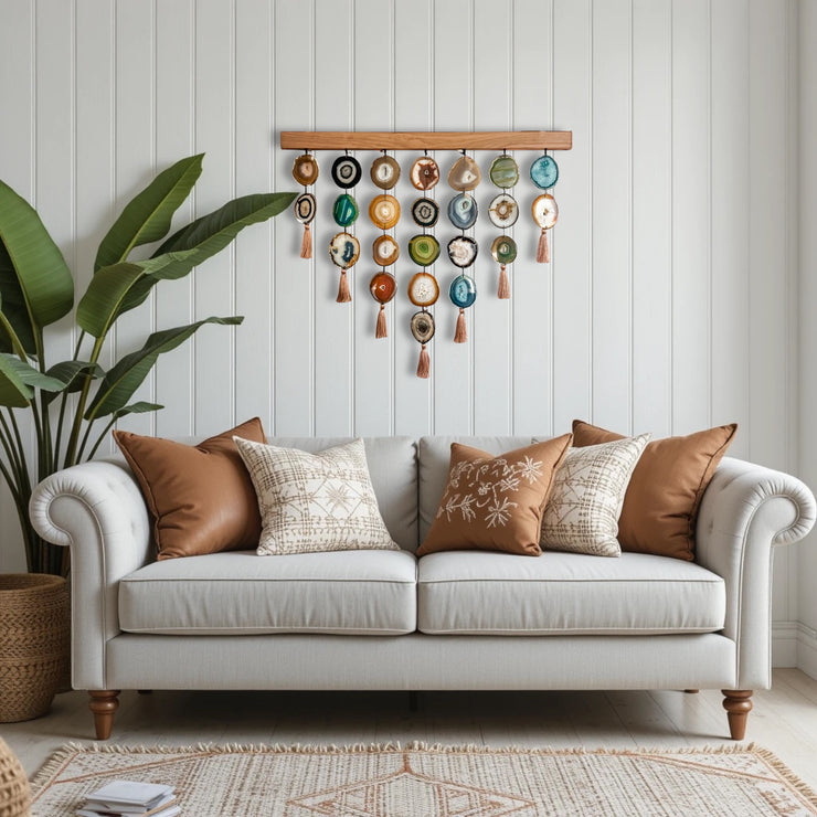 a white couch sitting in a living room next to a potted plant