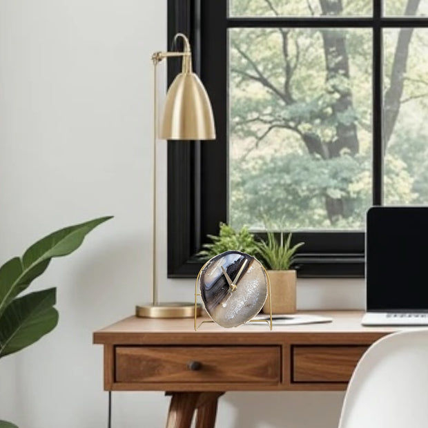 a desk with a laptop and a potted plant