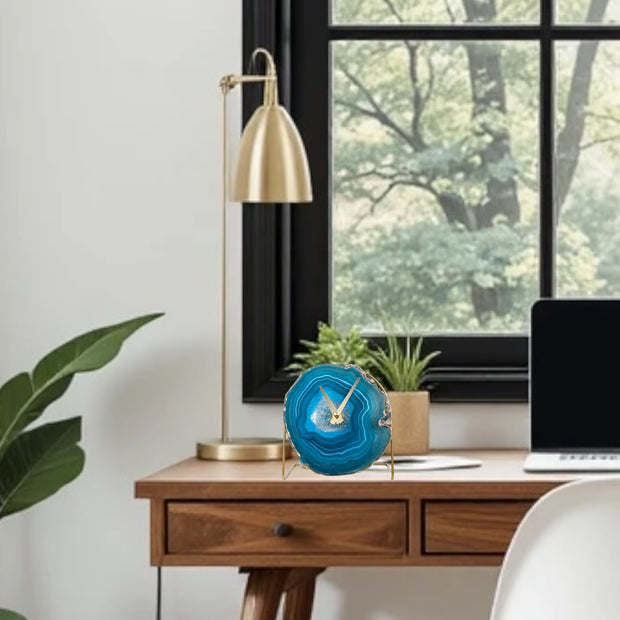 a desk with a laptop and a plant in front of a window