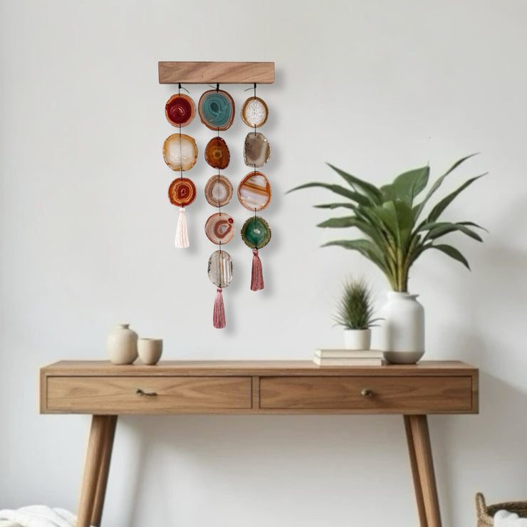 a wooden table topped with a plant next to a white wall