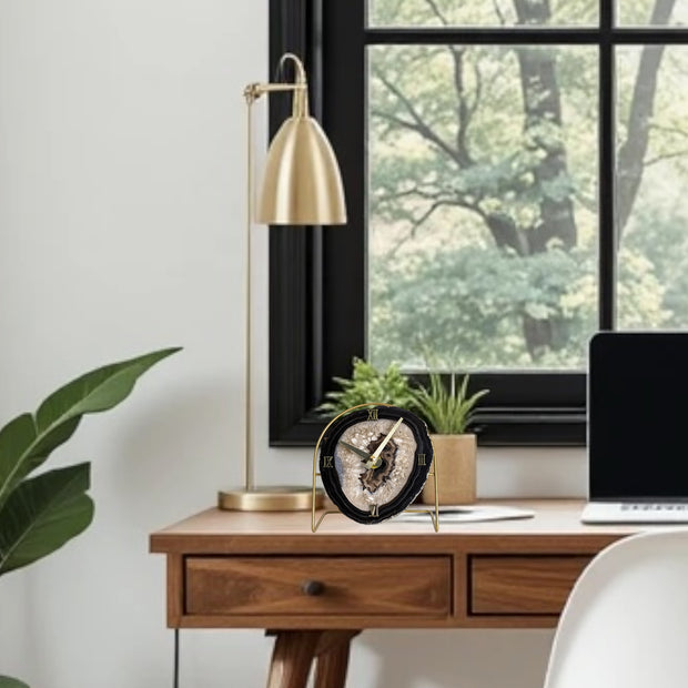 a desk with a laptop and a plant on it