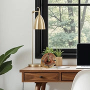 a laptop computer sitting on top of a wooden desk