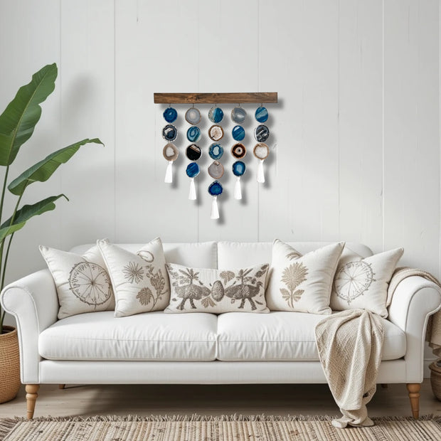 a white couch sitting in a living room next to a potted plant