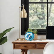 a laptop computer sitting on top of a wooden desk