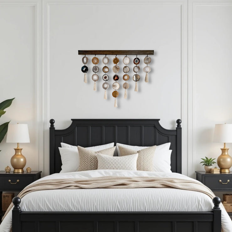 a bedroom with a bed, two nightstands and a wall hanging