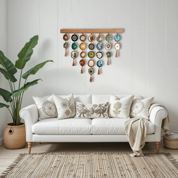 a white couch sitting in a living room next to a potted plant